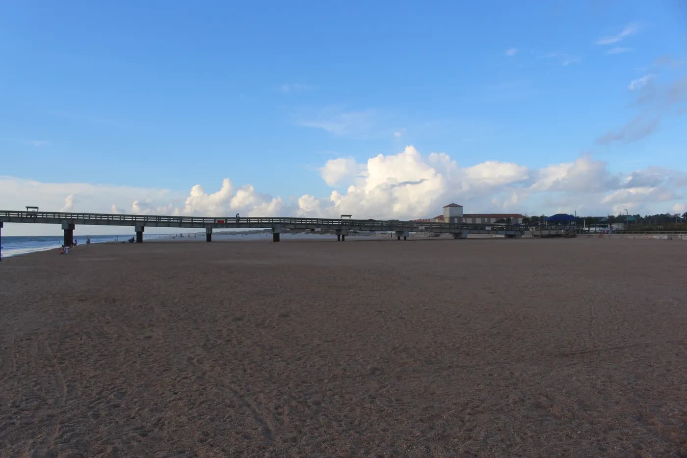 Wide sandy beach beside the St. Johns County Ocean Pier in St. Augustine Beach