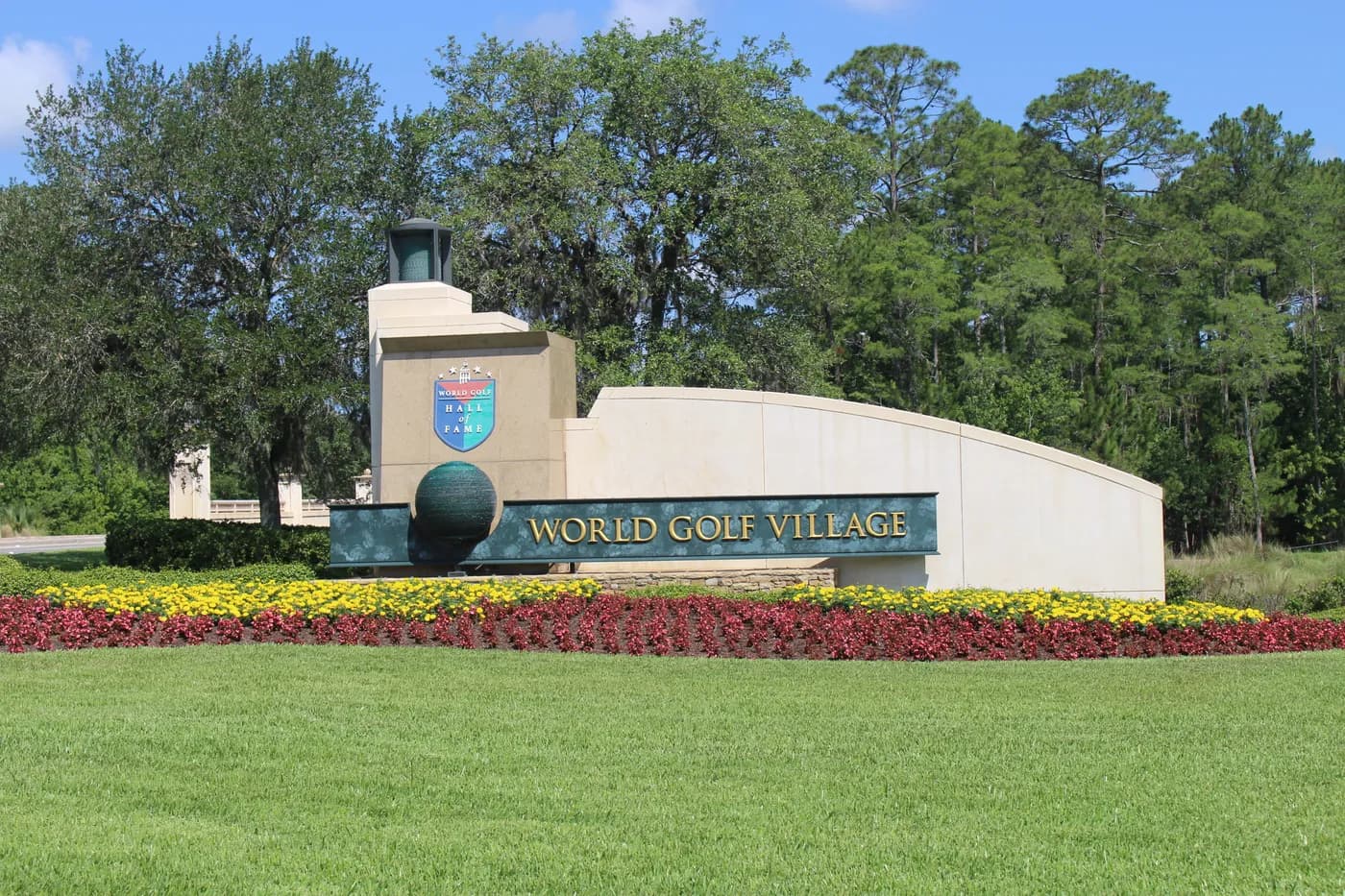 World Golf Village entrance sign bordered by flowers and trees, photographed in 2016